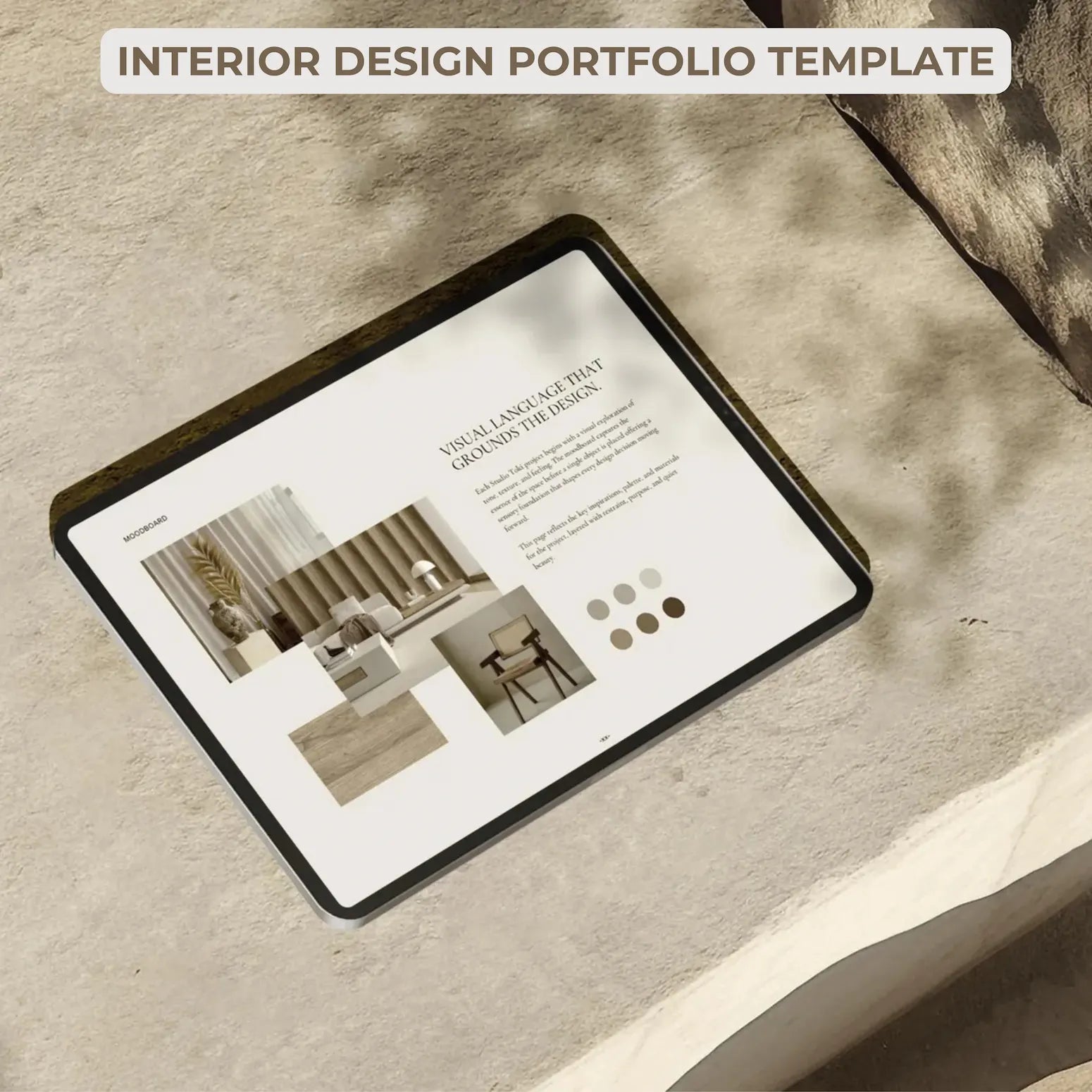 Tablet displaying an interior design portfolio template on a textured surface