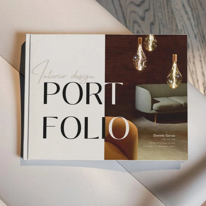 Interior design portfolio book with images of a sofa and light fixtures on a neutral background