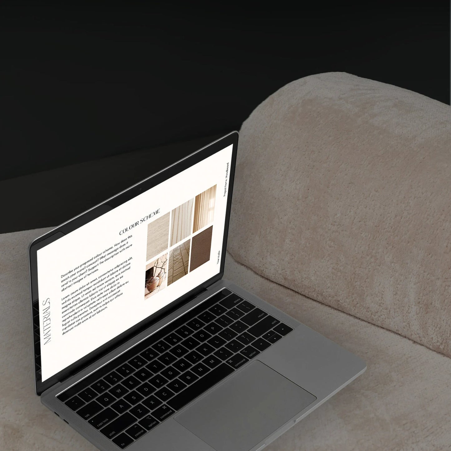 Laptop on a table with a beige cushion in the background