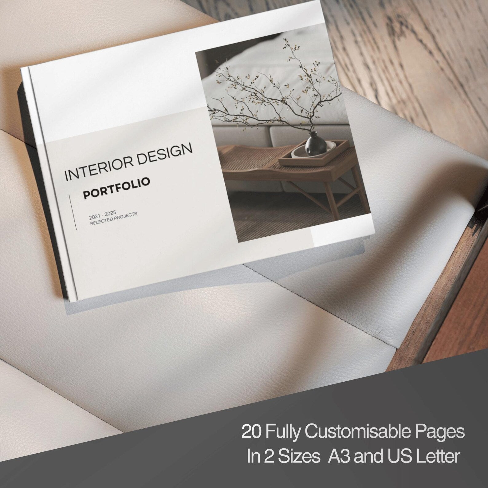 Interior design portfolio book on a wooden surface with text about customizable pages.