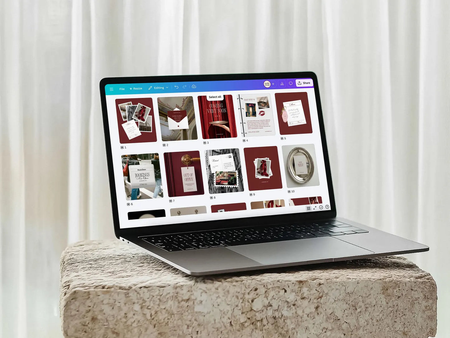 Laptop on a stone surface with a white curtain background