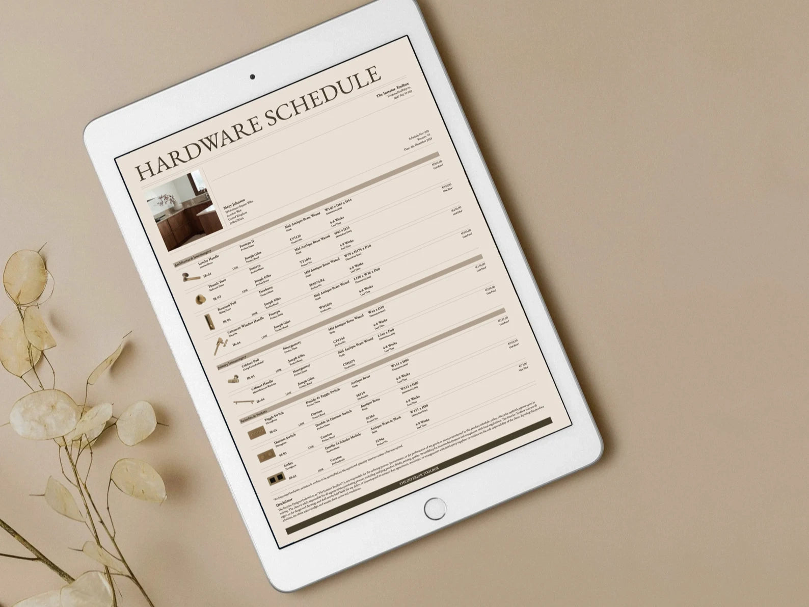 Tablet displaying a 'Hardware Schedule' on a beige background with dried flowers.