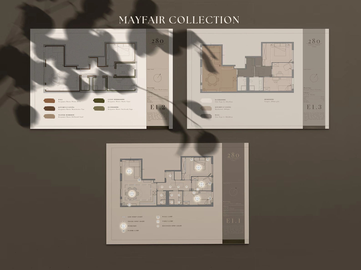 Floor plan brochures for the Mayfair Collection on a dark surface with plant shadows.