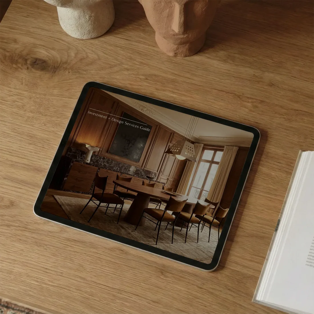 Tablet displaying a room image on a wooden surface