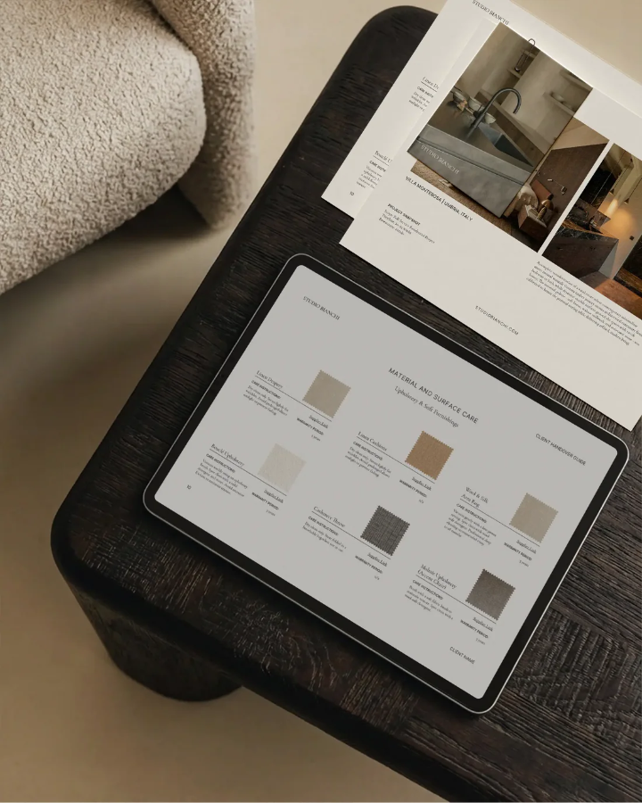 Tablet displaying color swatches on a wooden surface with a paper on top