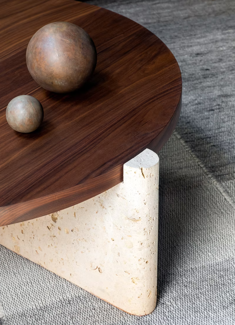 Wooden side table with spherical objects on a textured surface
