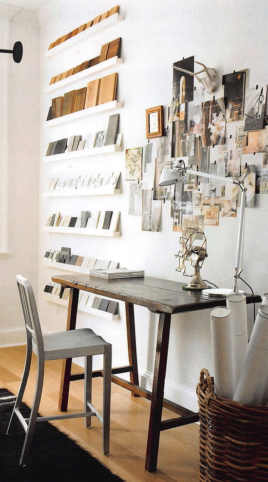 Modern home office with a desk, chairs, and wall art.